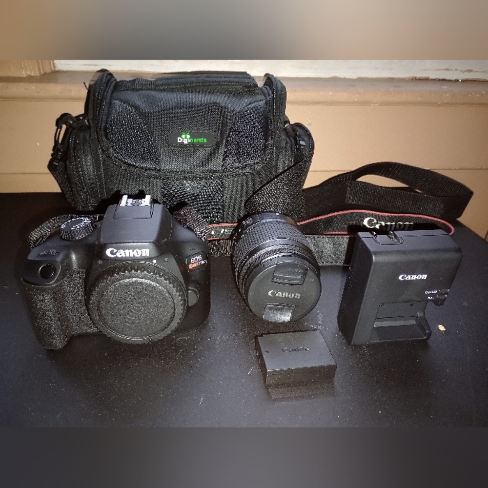 Digital Camera EOS Rebel T100, Zoom Lens EF-518-55mm, Strap, Battery & Charger.